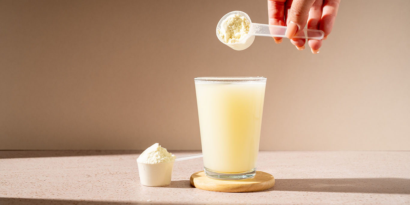 Creatine being poured into a glass of water